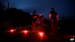 A man talks with officers at a roadblock near the Arkema Inc. chemical plant, Aug. 31, 2017, in Crosby, Texas. The plant that lost power after Harvey engulfed the area was rocked by multiple explosions early Thursday, the plant's operator said.