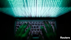 FILE - A man types on a computer keyboard.