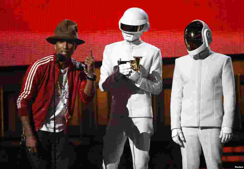 Pharrell Williams accepts the award for record of the year for Daft Punk for "Get Lucky" at the 56th annual Grammy Awards in Los Angeles, Jan. 26, 2014.