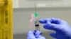 FILE - A clinical research nurse prepares the COVID-19 vaccine to administer to a volunteer, at a clinic in London, Aug. 5, 2020. (AP)