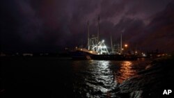 Crew members of a shrimp boat called the Sea Lion V prepare as they wait for Hurricane Laura to make landfall, Wednesday, Aug. 26, 2020, in Port Arthur, Texas. (AP Photo/Eric Gay)
