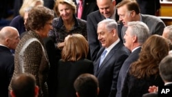 Israeli Prime Minister Benjamin Netanyahu, accompanied by House Majority Leader Kevin McCarthy of Calif., is greeted before addressing a joint meeting of Congress on Capitol Hill in Washington, Tuesday, March 3, 2015. 