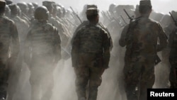 FILE - Afghan National Army (ANA) officers march during a training exercise at the Kabul Military Training Centre in Afghanistan, Oct. 7, 2015. 