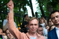 FILE - Russian investigative journalist Ivan Golunov greets colleagues and supporters as he leaves an Investigative Committee building in Moscow, Russia, June 11, 2019.