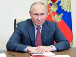 FILE - Russian President Vladimir Putin chairs a video conference meeting with members of the Security Council at the Novo-Ogaryovo state residence outside Moscow, Russia, May 14, 2021. (Sputnik/Sergey Ilyin/Kremlin via Reuters)