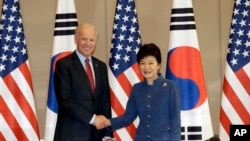 South Korean President Park Geun-hye, right, shakes hands with U.S. Vice President Joe Biden before their meeting at the presidential Blue House in Seoul, South Korea, Friday, Dec. 6, 2013.
