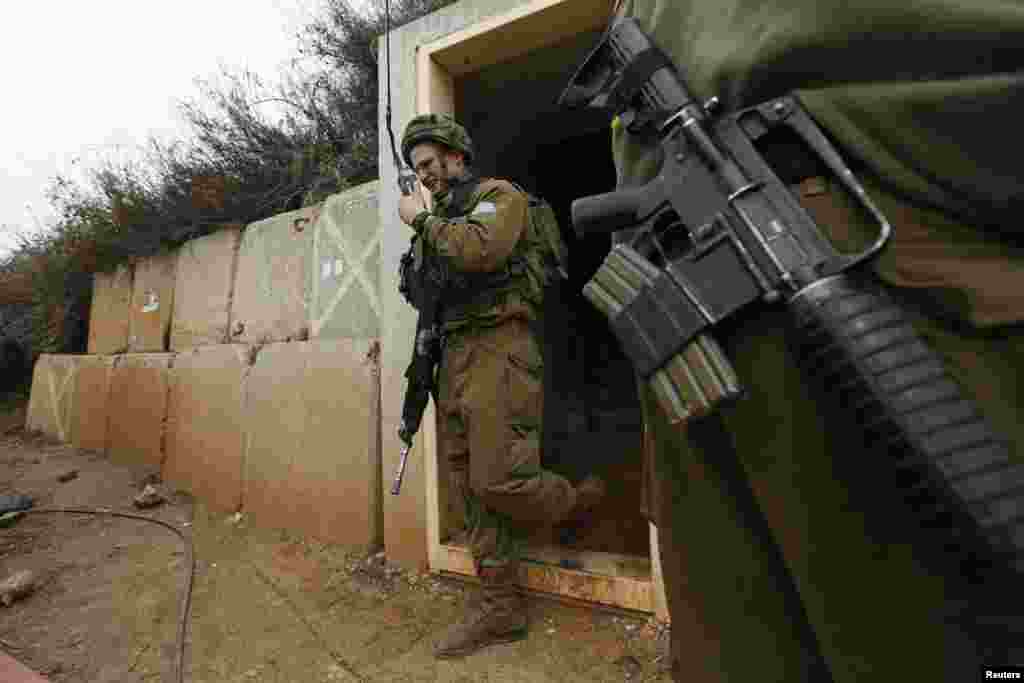 An Israeli soldier walks out of a military bunker on the Israel-Lebanon border near the northern town of Metula, Israel, Dec. 29, 2013. 