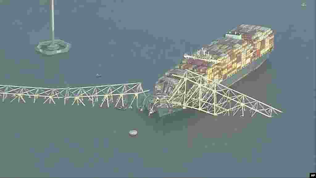 Parts of the Francis Scott Key Bridge remain after a container ship collided with one of the bridge’s supports, March 26, 2024 in Baltimore. (WJLA via AP)
