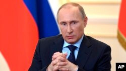 President Vladimir Putin answers journalists' questions on current situation in Ukraine at the Novo-Ogaryovo presidential residence outside Moscow, March 4, 2014. 