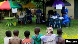 Ugandan civilians queue to be vaccinated against the Ebola virus in Kirembo village, near the border with the Democratic Republic of Congo in Kasese district, Uganda, June 16, 2019. 