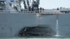 FILE - damage is visible as the guided-missile destroyer USS John S. McCain steers towards Changi naval base in Singapore following a collision with the merchant vessel Alnic MC. 