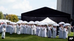 Para umat Katolik di Polandia tampak menghadiri upacara beatifikasi dari Kardinal Stefan Wyszynski dan Bunda Elzbieta Roza Czacka di depan gereja Providence di Warsawa pada 12 September 2021. (Foto: AP)