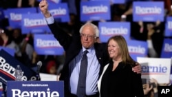 FILE - Sen. Bernie Sanders, I-Vt. (L) and his wife, Jane O'Meara Sanders, greet supporters as they leave after his 2020 presidential campaign stop at Navy Pier in Chicago, March 3, 2019.