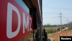 A sign advertising properties within and along the demilitarized zone (DMZ) that separates the two Koreas, is seen at a real estate agency in Munsan, South Korea, May 10, 2018. 