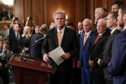 House Minority Leader Kevin McCarthy of Calif., center, walks up to the podium during a news conference on Capitol Hill in Washington, Oct. 31, 2019.