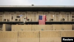 FILE - A U.S. flag hangs off of a housing unit inside of Bagram Air Field in the Parwan province of Afghanistan, Jan. 2, 2015. 
