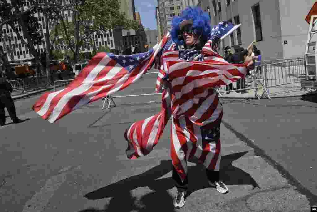 A U.S. women's soccer team fan is covered in American flags during the ticker-tape parade to celebrate their World Cup victory, July 10, 2015, in New York.