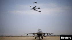 A U.S. Air Force B-52 flies over Osan Air Base in Pyeongtaek, South Korea, Jan. 10, 2016. 