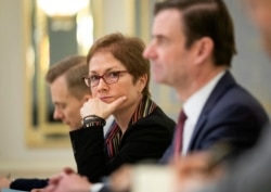 FILE - U.S. Ambassador to Ukraine Marie Yovanovitch, center, sits during her meeting with Ukrainian President Petro Poroshenko in Kyiv, Ukraine, March 6, 2019.