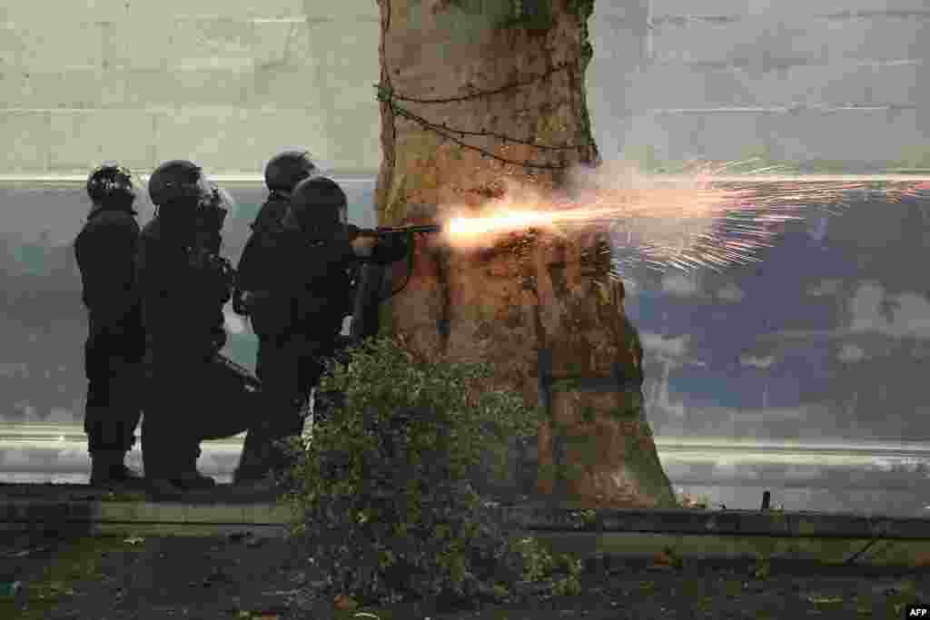 Police fire tear gas toward protesters during the fifth straight night of demonstrations against the government's postponement of EU accession talks until 2028, in central Tbilisi, Georgia.