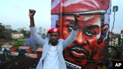 FILE - Ugandan politician Robert Kyagulanyi Ssentamu, better known as Bobi Wine, gestures in Nairobi, Kenya, Oct. 12, 2018. 