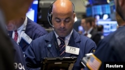 Traders work on the floor of the New York Stock Exchange Sept. 11, 2015.
