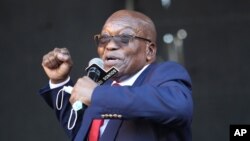 Former South African President Jacob Zuma, addresses supporters outside the High Court in Pietermaritzburg, South Africa, Wednesday May 26, 2021 where he faces charges of corruption. Zuma pleaded not guilty to corruption, racketeering, fraud, tax…