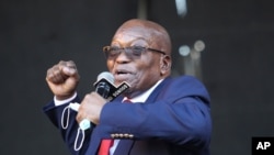 Former South African President Jacob Zuma, addresses supporters outside the High Court in Pietermaritzburg, South Africa, Wednesday May 26, 2021 where he faces charges of corruption. Zuma pleaded not guilty to corruption, racketeering, fraud, tax…