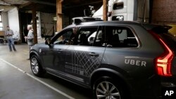 FILE - An Uber driverless car is displayed in a garage in San Francisco, Dec. 13, 2016. Uber announced Dec. 22, 2016, it is moving its self-driving cars to Arizona.