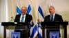 Avigdor Lieberman, head of the Yisrael Beitenu party, left, and Israeli Prime Minister Benjamin Netanyahu talk to reporters after signing a coalition deal to broaden the government's parliamentary majority at the Knesset in Jerusalem, May 25, 2016. 
