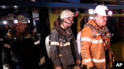 Photo provided by Russian Emergency Situations Ministry press service on Feb. 28, 2016 shows rescuers leaving an elevator in Vorkuta. Officials say a total of 36 people are believed to have died at a coal mine where a methane gas leak triggered three explosions and the collapse of the mine.