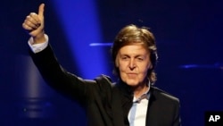 FILE - Paul McCartney performs during the first U.S concert of his "Out There!" world tour in Orlando, Fla., May 18, 2013.