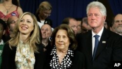 Former President Bill Clinton and his daughter, Chelsea, flank Dorothy Rodham, mother of then-Democratic presidential hopeful Sen. Hillary Rodham Clinton, D-N.Y., as she speaks at her Pennsylvania primary election night party, April 22, 2008. (file photo)