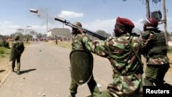FILE - A riot policeman fires a teargas canister to disperse demonstrators during protests in Narok, Kenya, January 26, 2015.