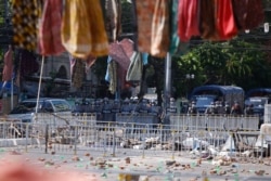 Riot police stand in formation in front of road barricade, as protesters hang women's clothing overhead to mark the International Women's Day in Yangon, Myanmar, March 8, 2021.