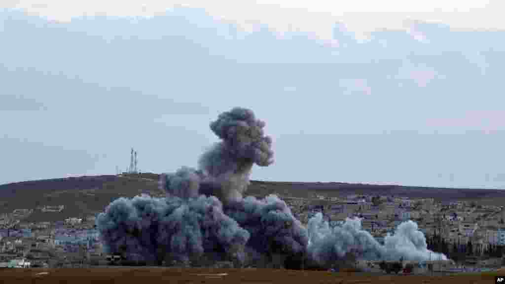 Smoke rises above the Syrian city of Kobani after an airstrike by the U.S.-led coalition, seen from a hilltop on the outskirts of Suruc, near the Turkey-Syria border, Nov. 2, 2014.