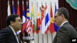 Russian Deputy Foreign Minister Igor Morgulov, left, talks with ASEAN's Deputy Secretary-General Nyan Lynn, right, before the ASEAN-Russia Ministerial Meeting in Phnom Penh, Cambodia, July 11, 2012.