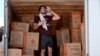 Ethan Hickman utiliza una toalla para secarse el sudor mientras se toma un descanso de descargar un contenedor bajo un calor sofocante, antes de la apertura de un puesto el lunes 17 de junio de 2024, en Weldon Spring, Missouri, Estados Unidos.