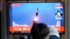 韩国民众在首尔一个火车站观看电视播放的朝鲜试射导弹新闻画面。（2022年1月27日）