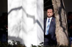 FILE - White House Social Media Director Dan Scavino listens to President Donald Trump speak during an event in the Rose Garden at the White House, Feb. 15, 2019.