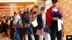 FILE - Job applicants line up at the Seminole Hard Rock Hotel & Casino Hollywood during a job fair in Hollywood, Florida, June 4, 2019.