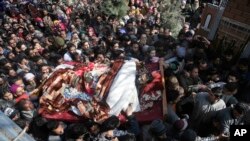 Kashmiri villagers shout slogans as they carry the body of a civilian Suhail Ahmad during his funeral at Pinjura village 52 kilometers south of Srinagar, Indian controlled Kashmir, March 5, 2018. 