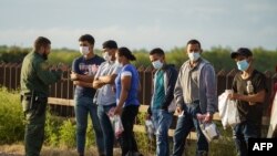 Migrants are processed by United States Border Patrol after crossing the US-Mexico border into the United States in Penitas, Texas on July 8, 2021.