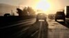 In this August 31, 2018, photo, morning commuters drive into downtown Los Angeles as the sun rises along Interstate 5.