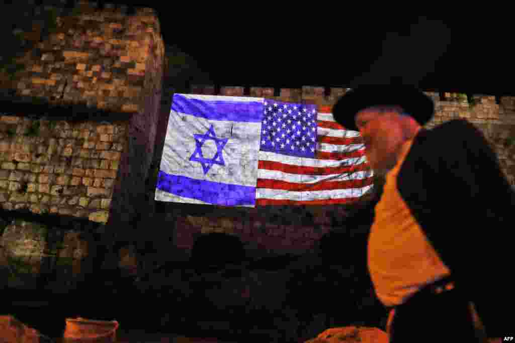 A giant U.S. flag screened alongside Israel's national flag by the Jerusalem municipality on the walls of the old city. U.S. President Donald Trump recognized the disputed city of Jerusalem as Israel's capital and kicked off the process of relocating the U.S. embassy there from Tel Aviv.