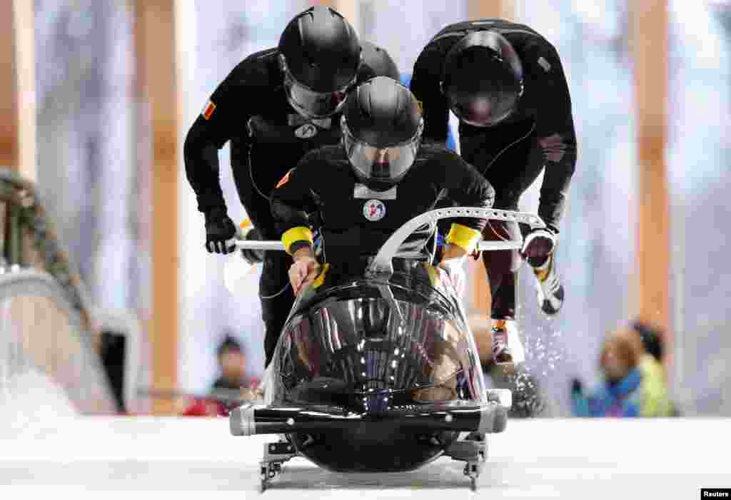 France's four-man bobsleigh pilot Thibault-Alexis Godefroy and his team start during an unofficial men's bobsleigh progressive training at the Sanki sliding center in Rosa Khutor, Feb. 6, 2014.