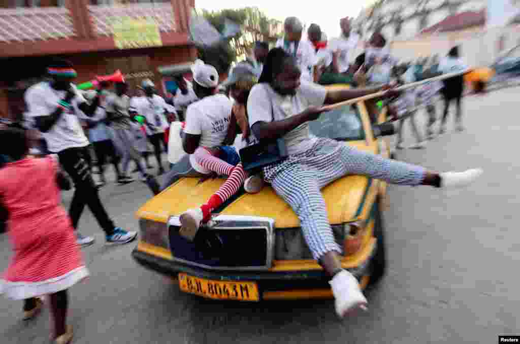 Supporters of Gambia’s President and presidential candidate Adama Barrow celebrate after partial results of the presidential elections showed Barrow leading in Banjul, Dec. 5, 2021.