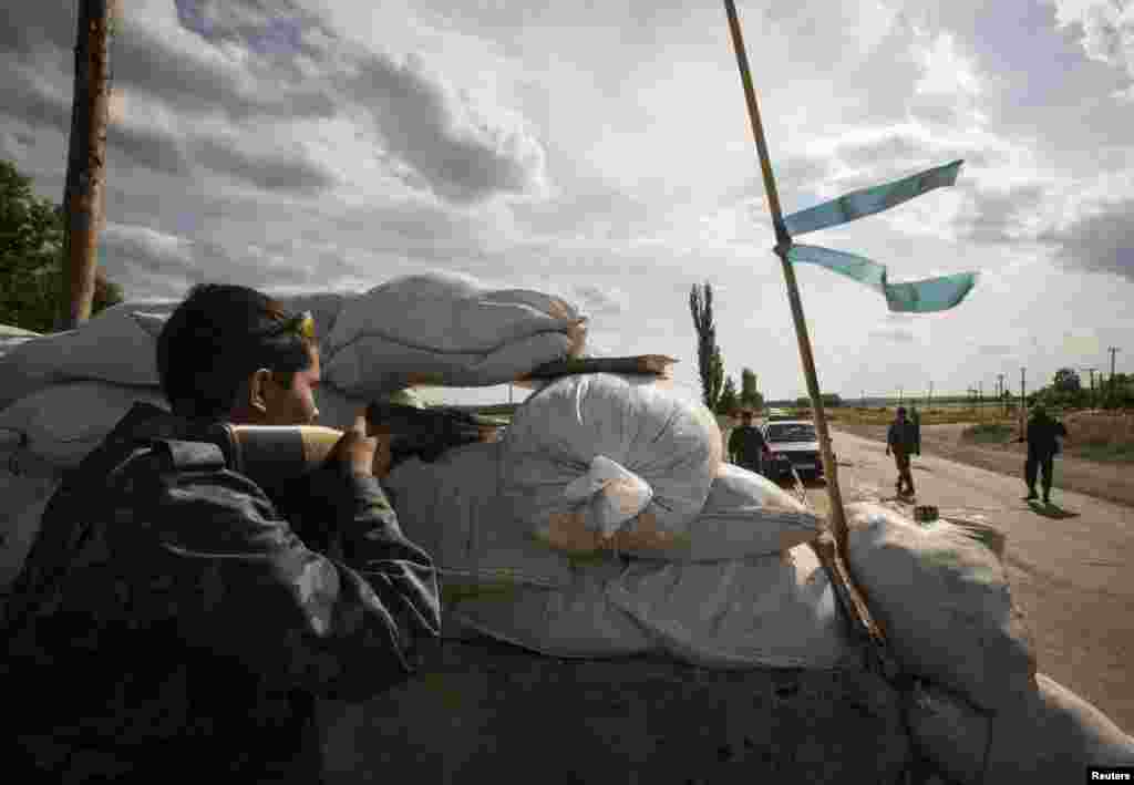 Pro-Russian separatists man a road checkpoint outside the town of Lysychansk in the Luhansk region of eastern Ukraine, June 24, 2014.