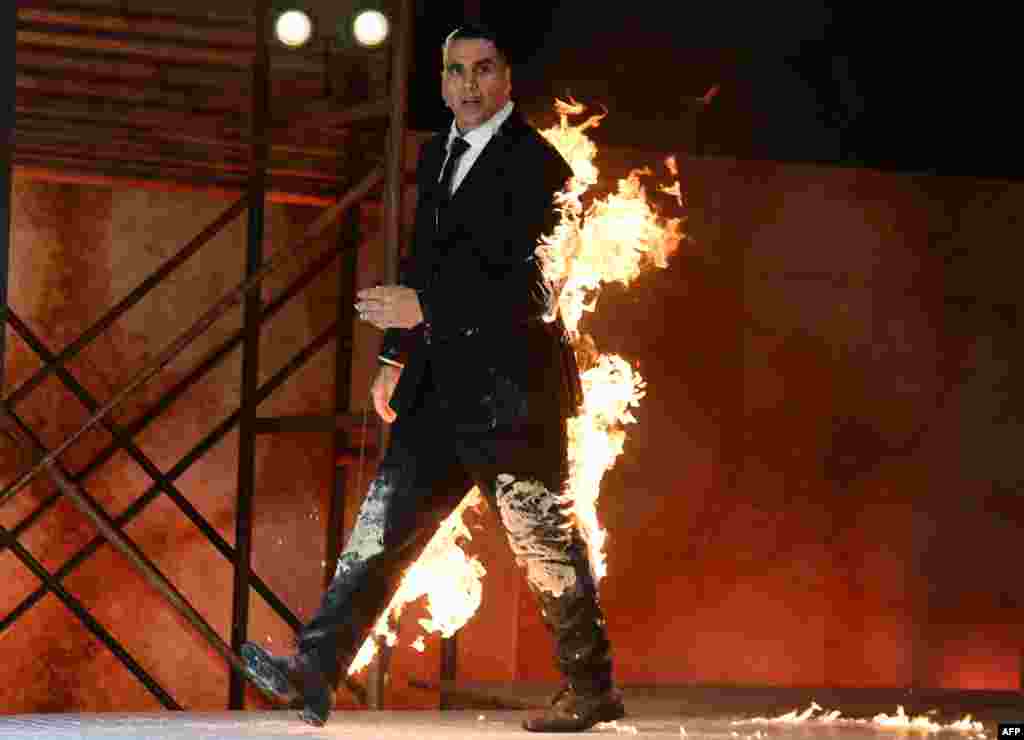 Indian Bollywood actor Akshay Kumar performs a fire stunt during the announcement of the upcoming Amazon Prime Video series 'The End' in Mumbai.