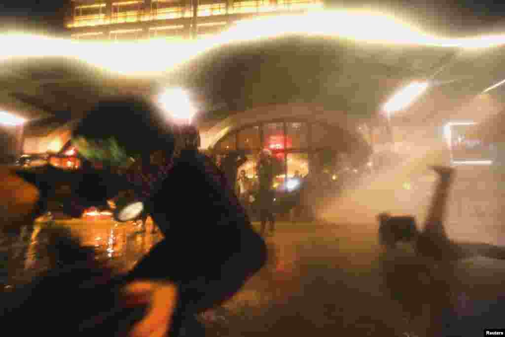 Protesters are attacked by a police water cannon next to Gezi Park near Istanbul's Taksim Square, June 15, 2013.